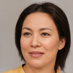 Joyful white adult female with medium  brown hair and brown eyes