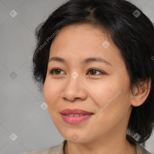 Joyful asian adult female with medium  brown hair and brown eyes