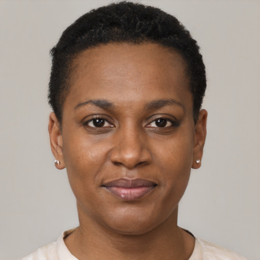 Joyful black young-adult female with short  brown hair and brown eyes
