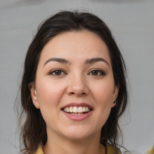 Joyful white young-adult female with medium  brown hair and brown eyes