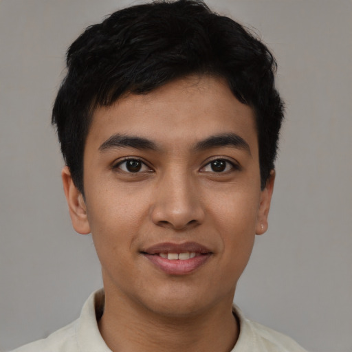 Joyful asian young-adult male with short  black hair and brown eyes