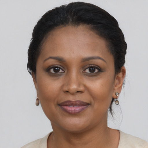 Joyful black young-adult female with medium  brown hair and brown eyes