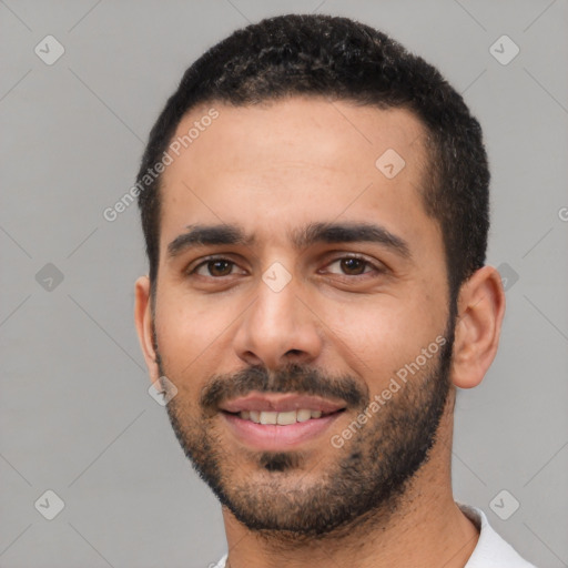 Joyful white young-adult male with short  black hair and brown eyes