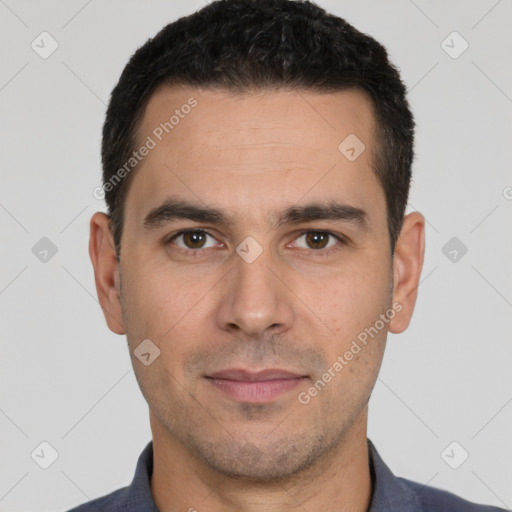 Joyful white young-adult male with short  black hair and brown eyes