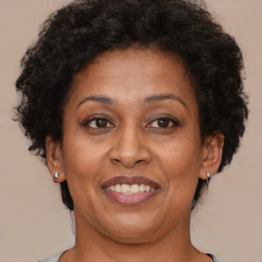 Joyful black adult female with short  brown hair and brown eyes
