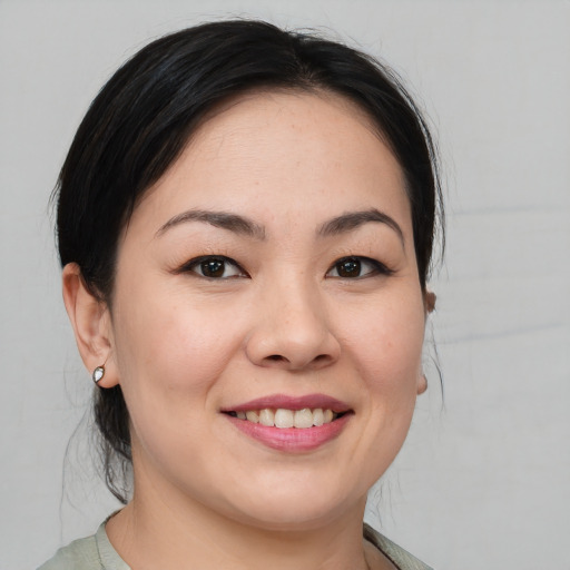 Joyful asian young-adult female with medium  brown hair and brown eyes