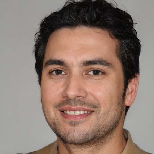 Joyful white young-adult male with short  black hair and brown eyes