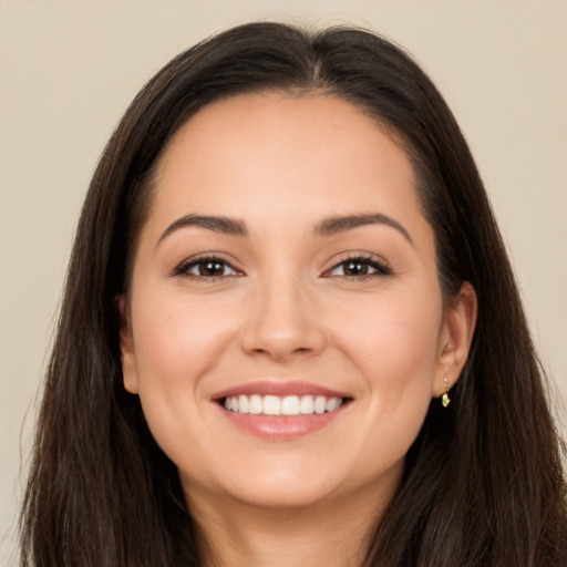 Joyful white young-adult female with long  brown hair and brown eyes