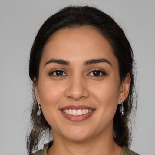 Joyful latino young-adult female with medium  brown hair and brown eyes