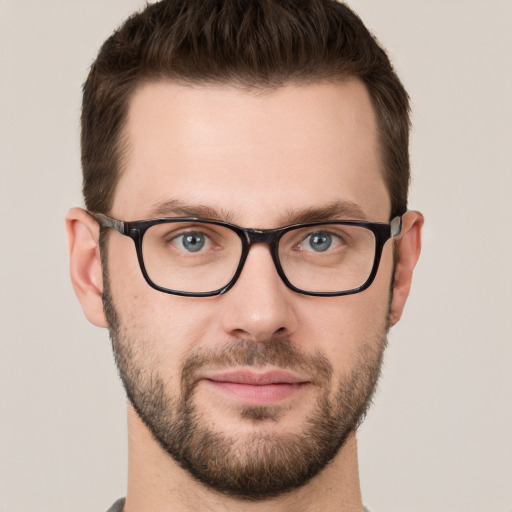 Joyful white young-adult male with short  brown hair and green eyes