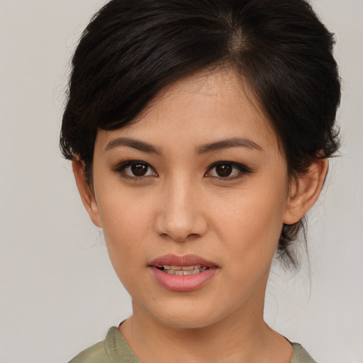 Joyful asian young-adult female with medium  brown hair and brown eyes