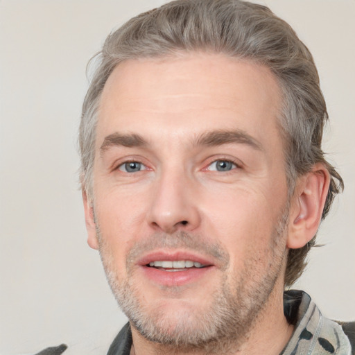 Joyful white adult male with short  brown hair and grey eyes