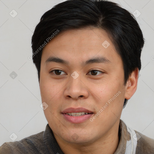 Joyful asian young-adult male with short  brown hair and brown eyes