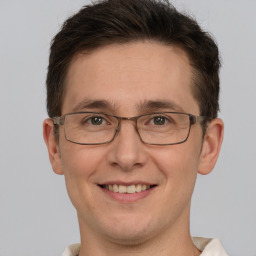 Joyful white adult male with short  brown hair and brown eyes