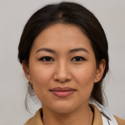 Joyful asian young-adult female with medium  brown hair and brown eyes