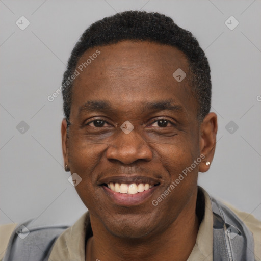 Joyful latino adult male with short  black hair and brown eyes