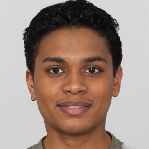 Joyful black young-adult male with short  black hair and brown eyes