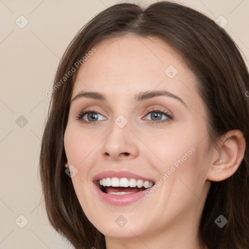 Joyful white young-adult female with long  brown hair and green eyes