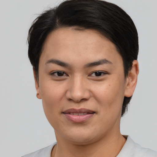 Joyful asian young-adult female with short  brown hair and brown eyes