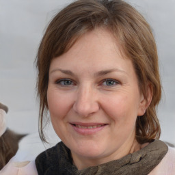 Joyful white adult female with medium  brown hair and brown eyes