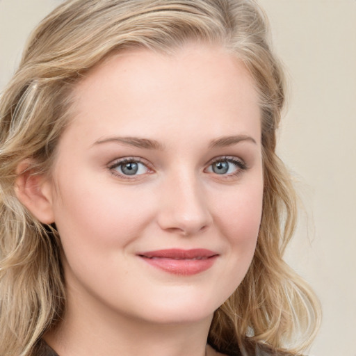 Joyful white young-adult female with long  brown hair and blue eyes