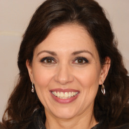 Joyful white adult female with long  brown hair and brown eyes