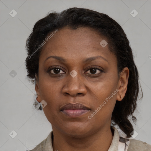 Joyful black adult female with short  brown hair and brown eyes
