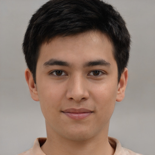 Joyful asian young-adult male with short  brown hair and brown eyes