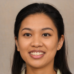 Joyful latino young-adult female with long  brown hair and brown eyes