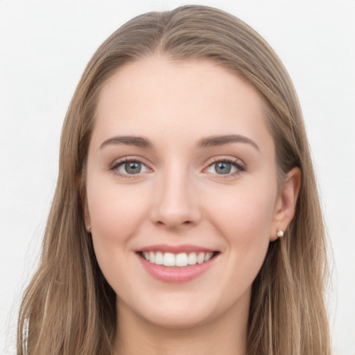 Joyful white young-adult female with long  brown hair and grey eyes