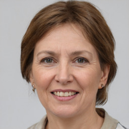 Joyful white adult female with medium  brown hair and grey eyes