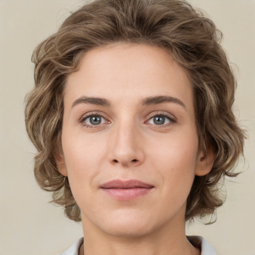 Joyful white young-adult female with medium  brown hair and green eyes