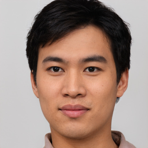 Joyful asian young-adult male with short  brown hair and brown eyes