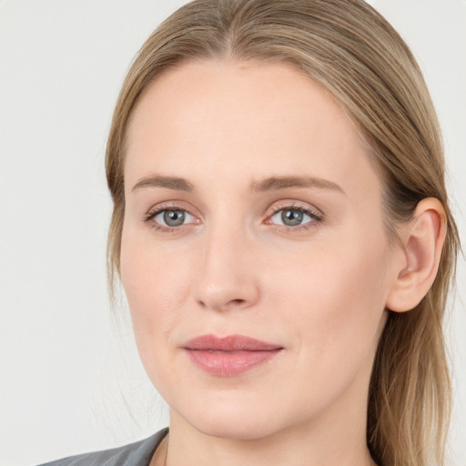 Joyful white young-adult female with long  brown hair and blue eyes