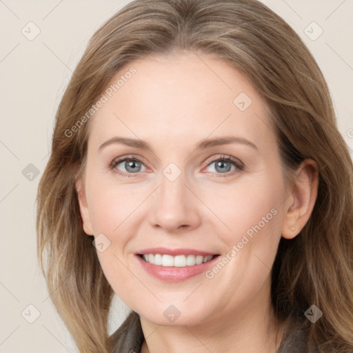 Joyful white adult female with long  brown hair and blue eyes