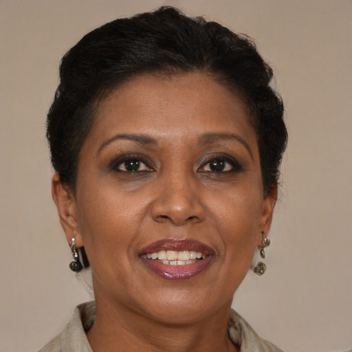 Joyful black adult female with short  brown hair and brown eyes