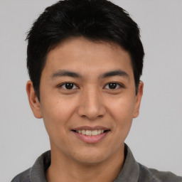 Joyful asian young-adult male with short  brown hair and brown eyes