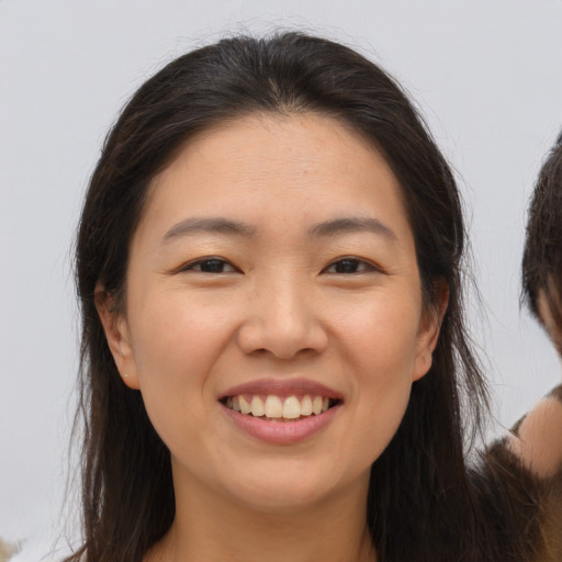 Joyful asian young-adult female with medium  brown hair and brown eyes