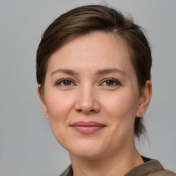 Joyful white young-adult female with short  brown hair and grey eyes