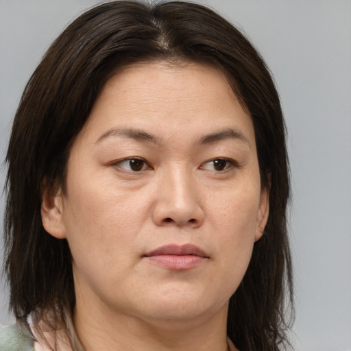 Joyful white adult female with medium  brown hair and brown eyes