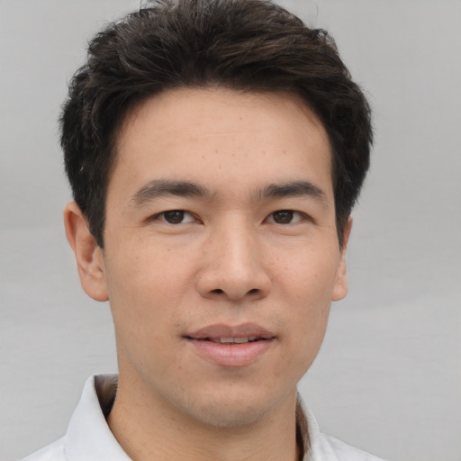 Joyful asian young-adult male with short  brown hair and brown eyes