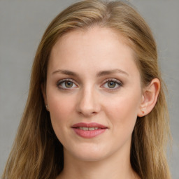 Joyful white young-adult female with long  brown hair and blue eyes