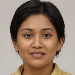 Joyful white young-adult female with medium  brown hair and brown eyes