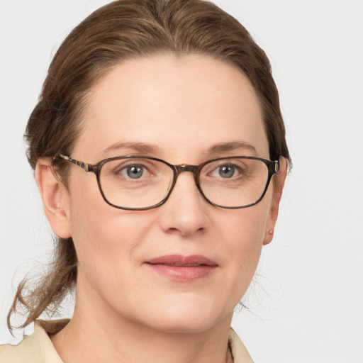 Joyful white adult female with medium  brown hair and grey eyes