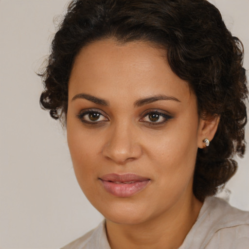 Joyful latino young-adult female with medium  brown hair and brown eyes
