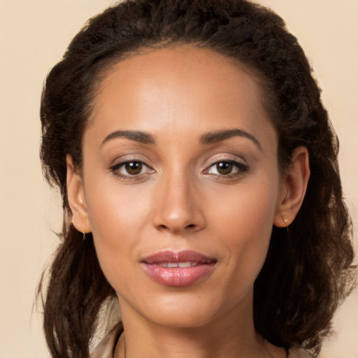 Joyful latino young-adult female with long  brown hair and brown eyes