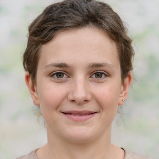 Joyful white young-adult female with medium  brown hair and green eyes