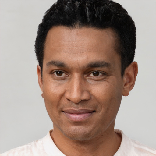 Joyful latino adult male with short  black hair and brown eyes