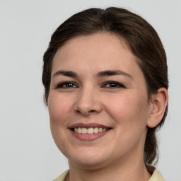 Joyful white young-adult female with medium  brown hair and brown eyes