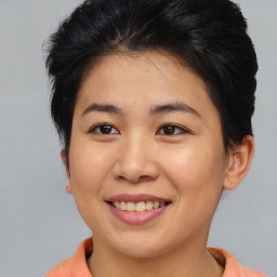 Joyful asian young-adult female with short  brown hair and brown eyes